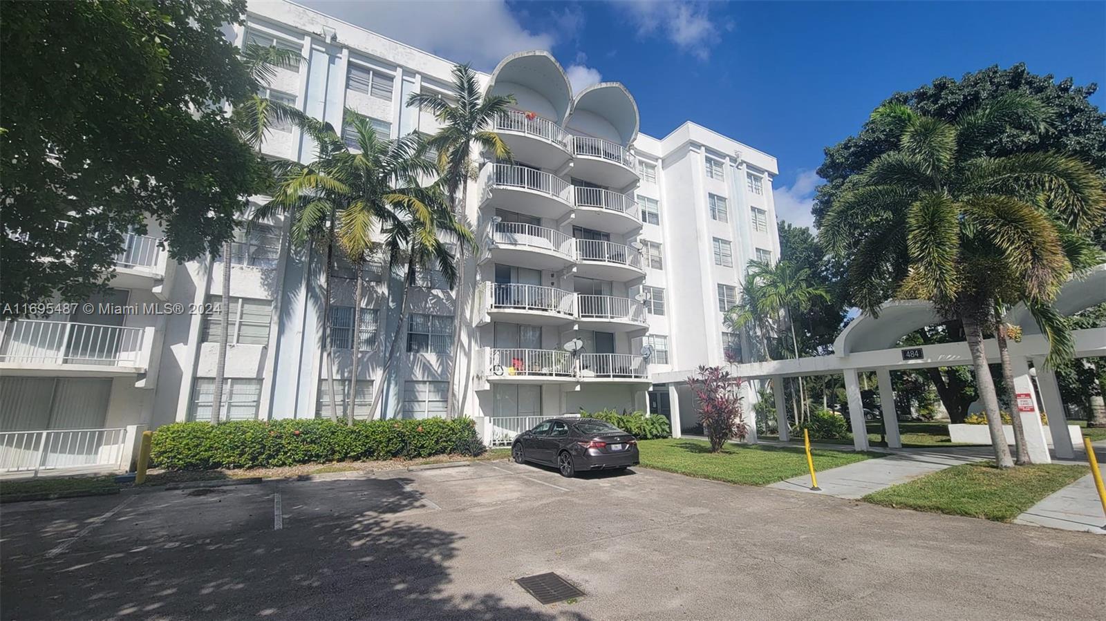 a front view of a building with garden