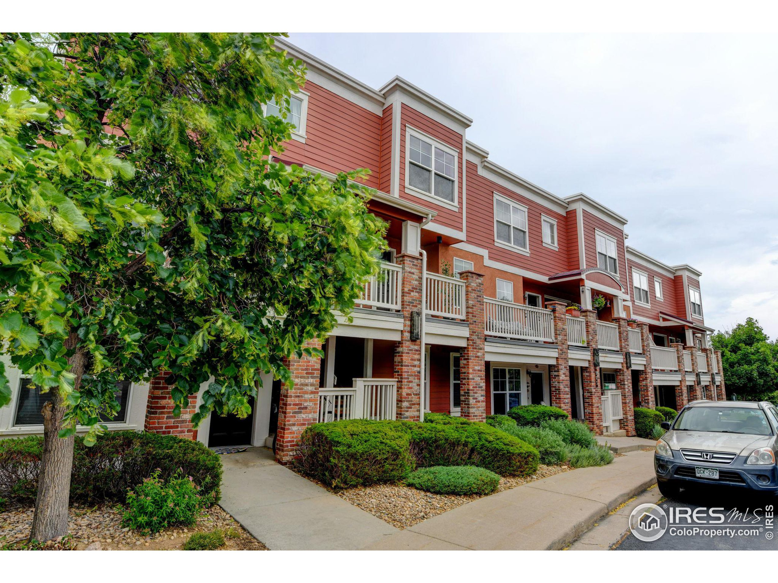 a front view of a residential apartment building with a yard