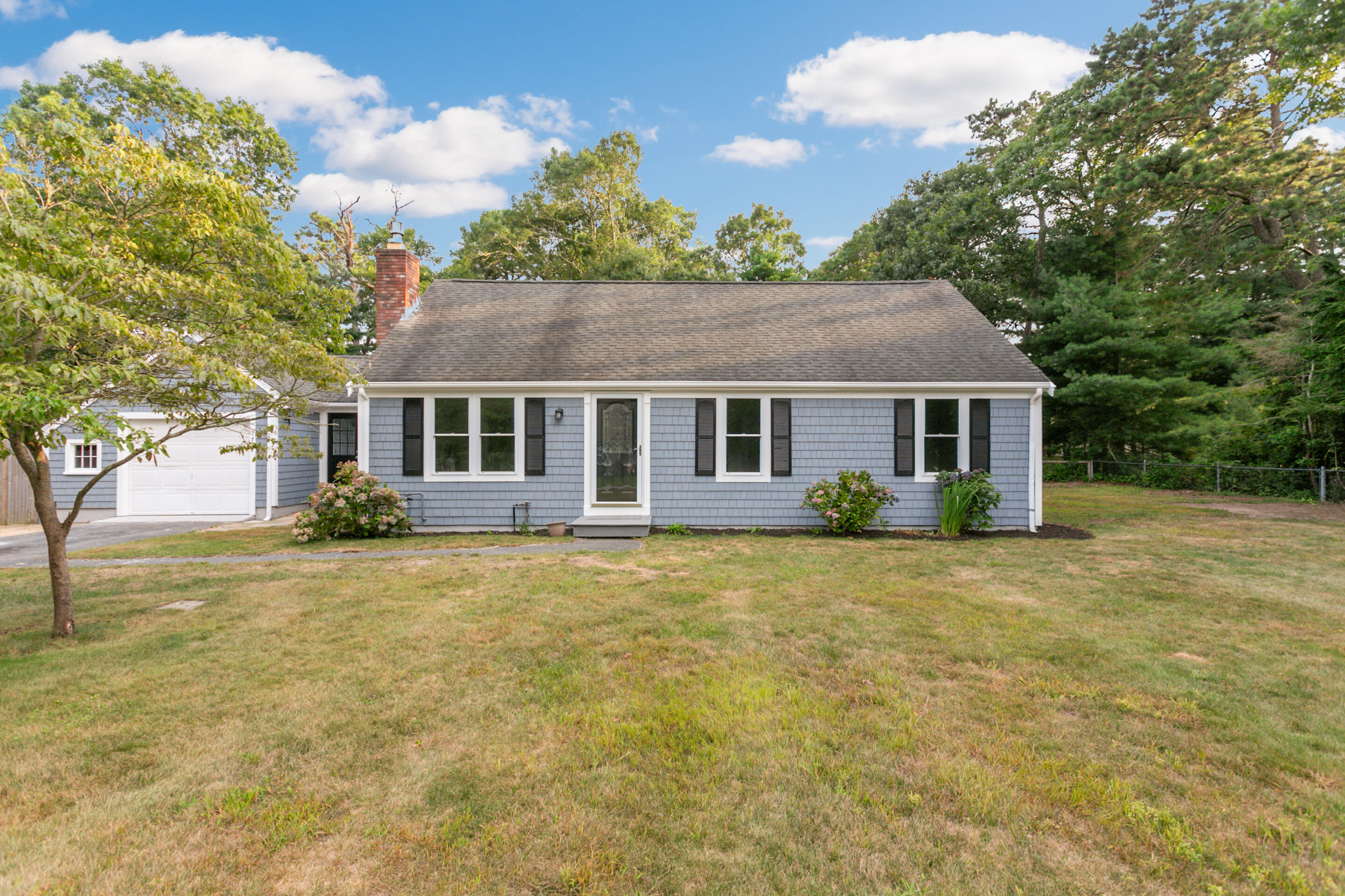 a front view of a house with a garden