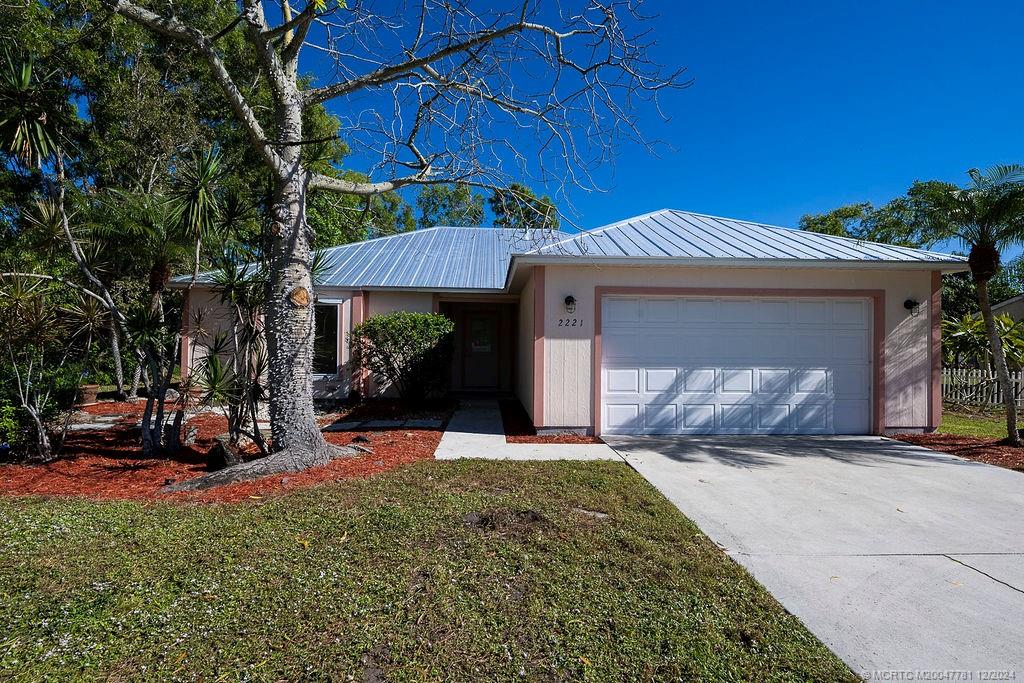 a view of a house with a patio and a yard