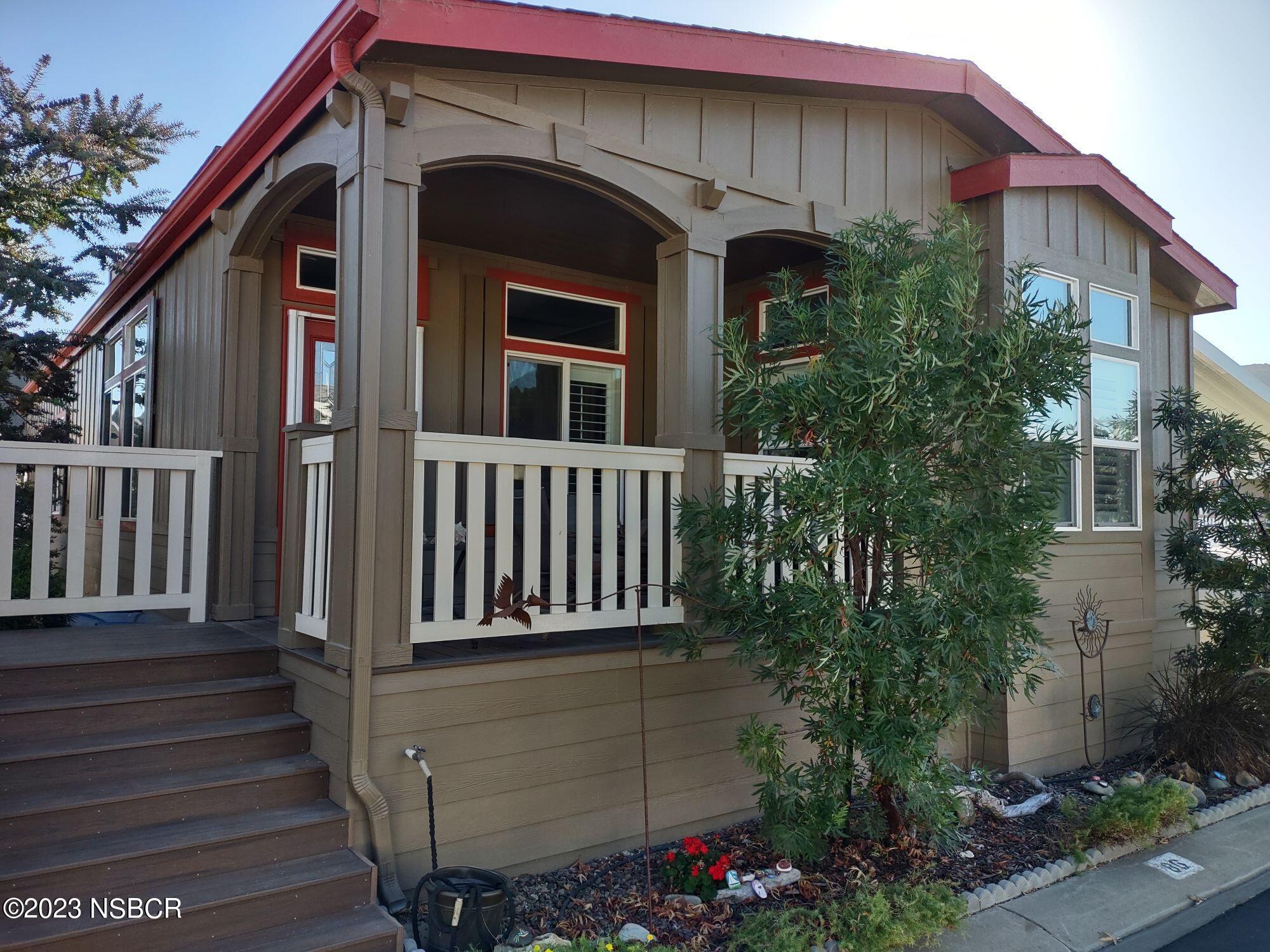 a front view of a house with plants