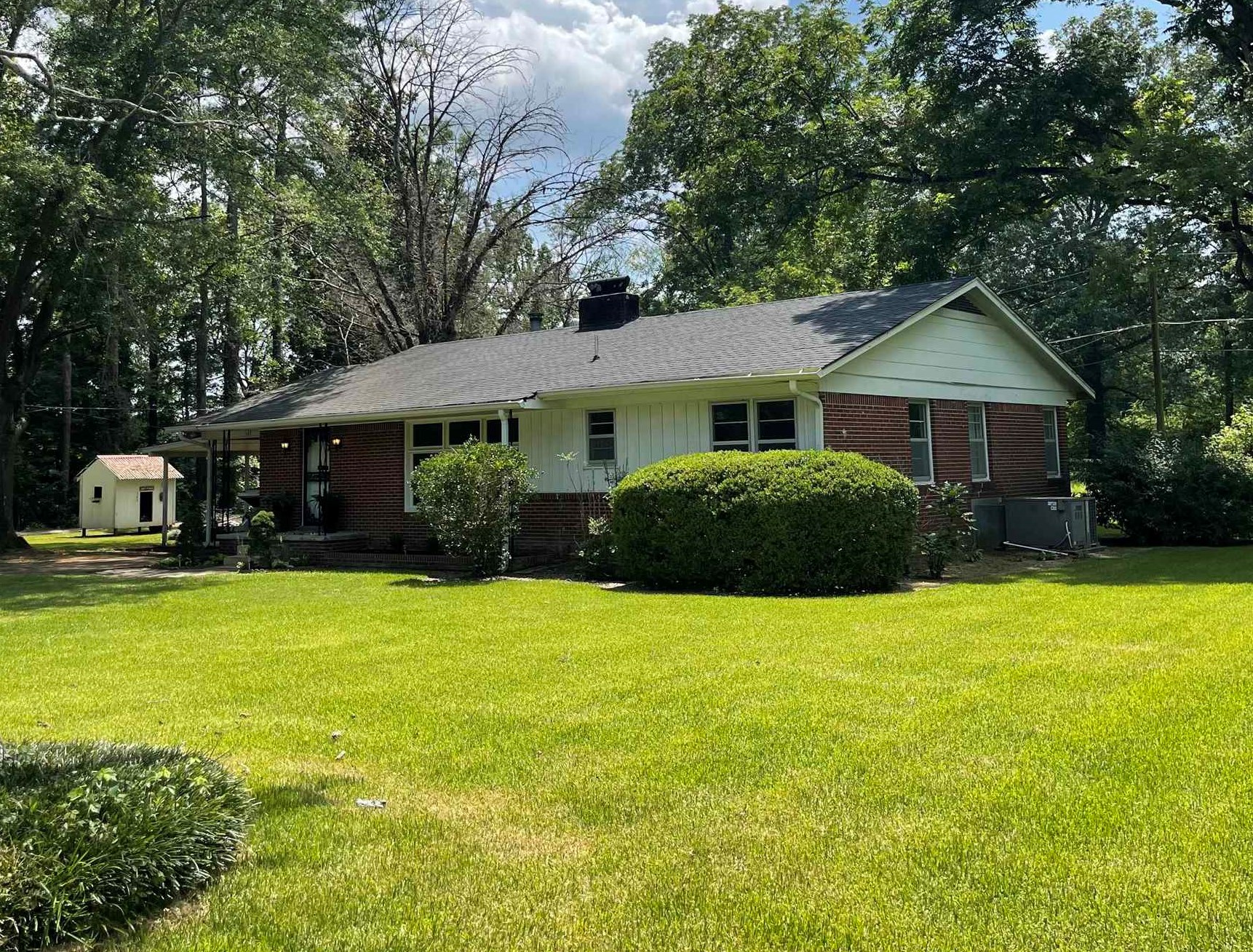 a front view of a house with a garden