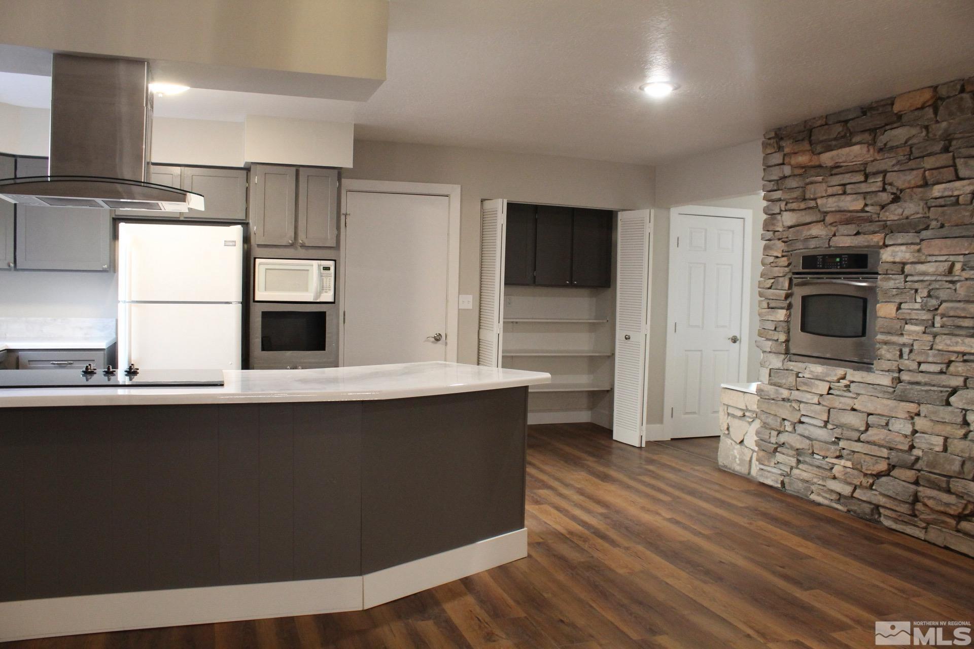 a kitchen with stainless steel appliances a refrigerator and a stove top oven