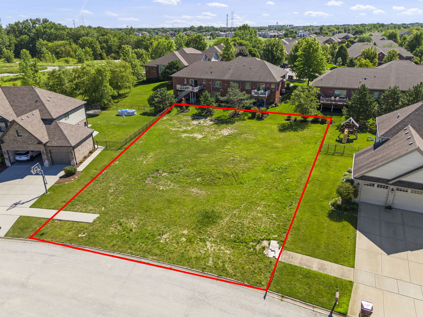 an aerial view of residential houses with outdoor space