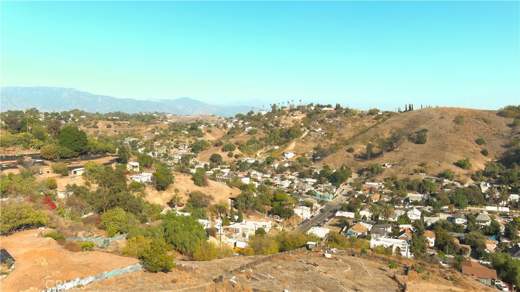 a view of a large building with mountains in the background