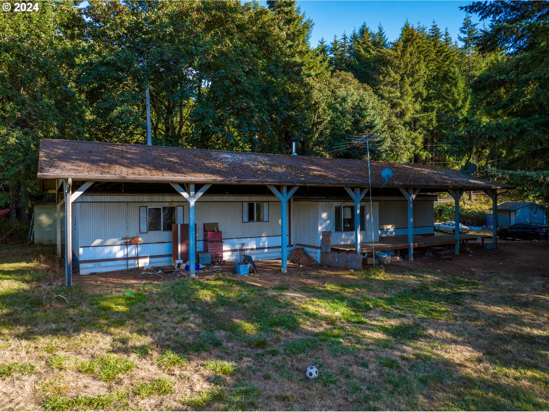 a view of a house with backyard porch and sitting area