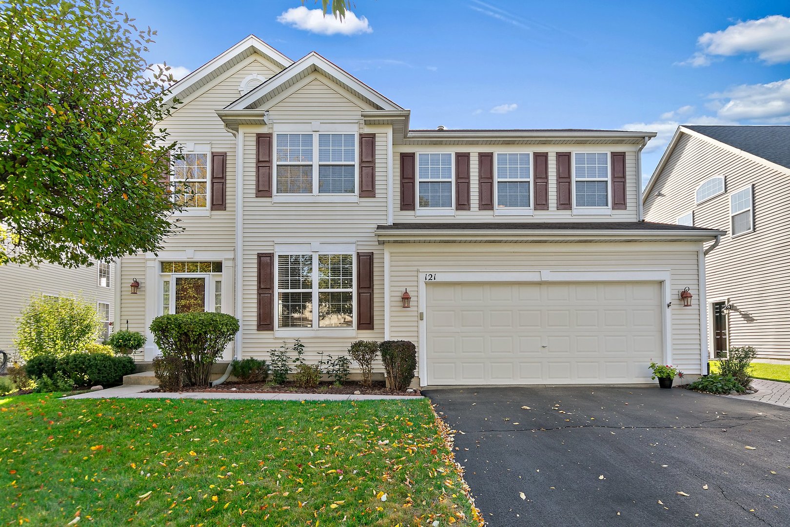 a front view of a house with a yard and garage