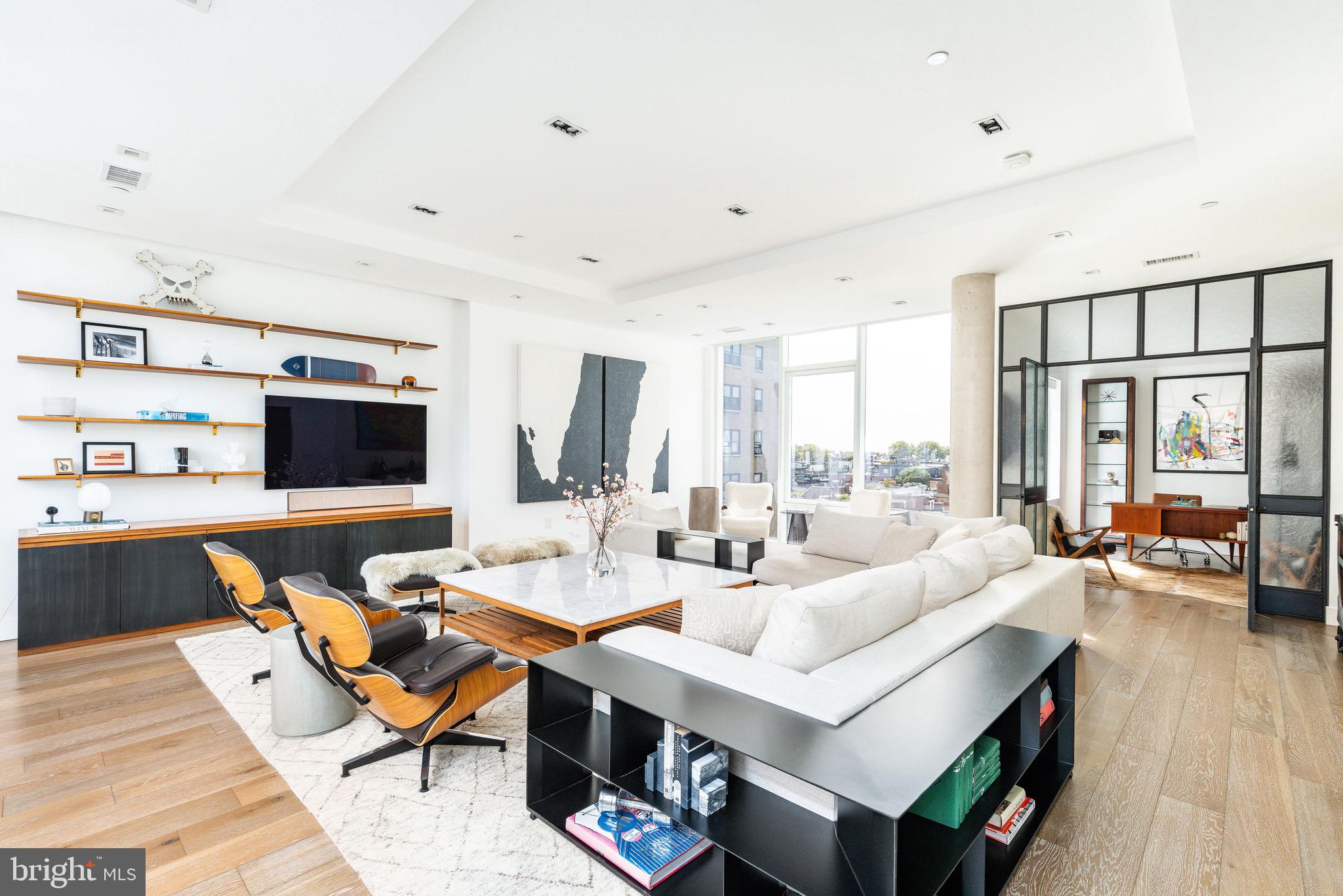 a living room with patio furniture and a flat screen tv