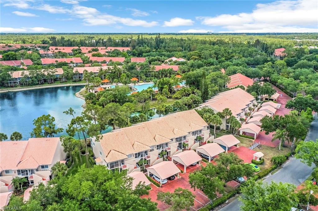 an aerial view of residential houses with outdoor space and lake view