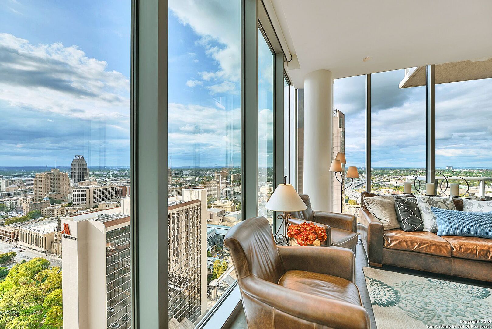 a living room with furniture and a floor to ceiling window