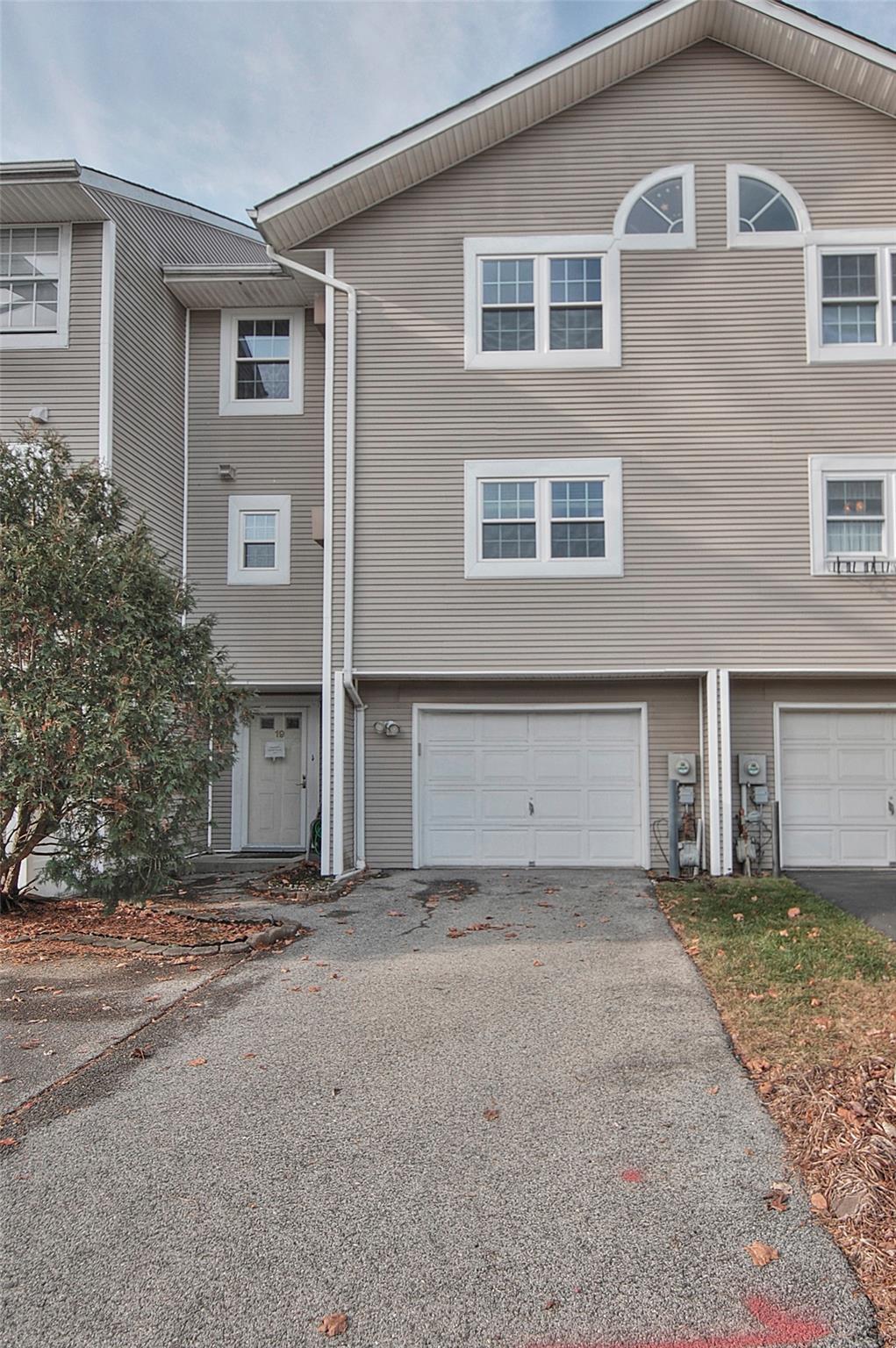 Townhome / multi-family property featuring a garage