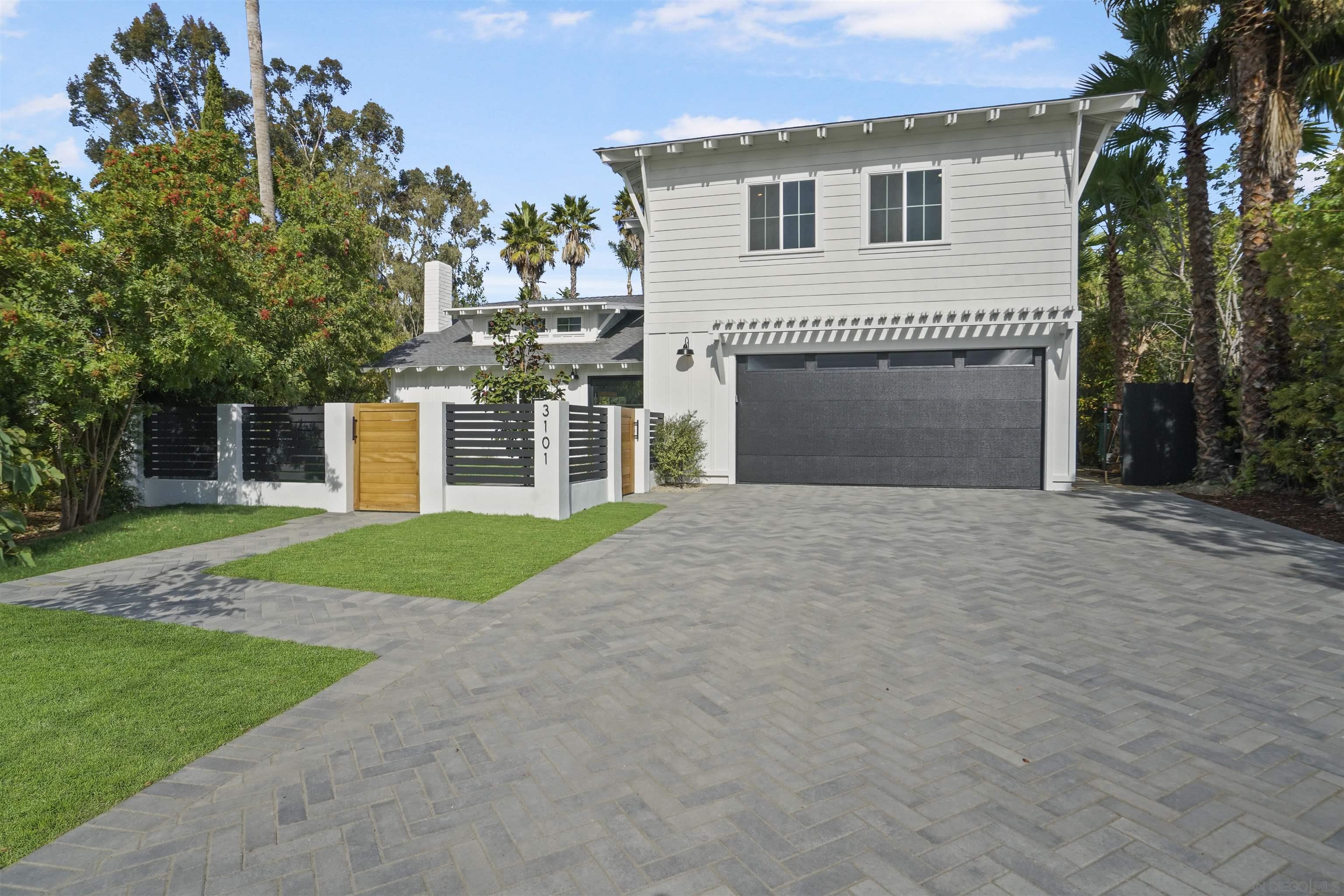 a view of a house with a yard and a garage