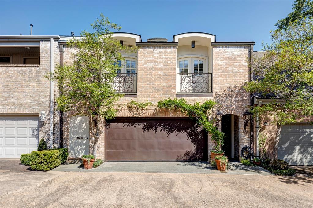 Welcome home!  This brick townhome has attached 2 car garage, charming wrought-iron balcony details, and dual gas lanterns flanking the arched entry!