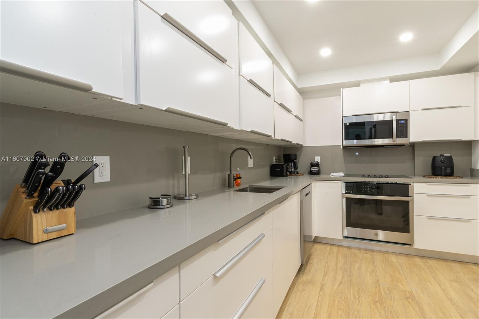 a kitchen with a sink a stove and cabinets