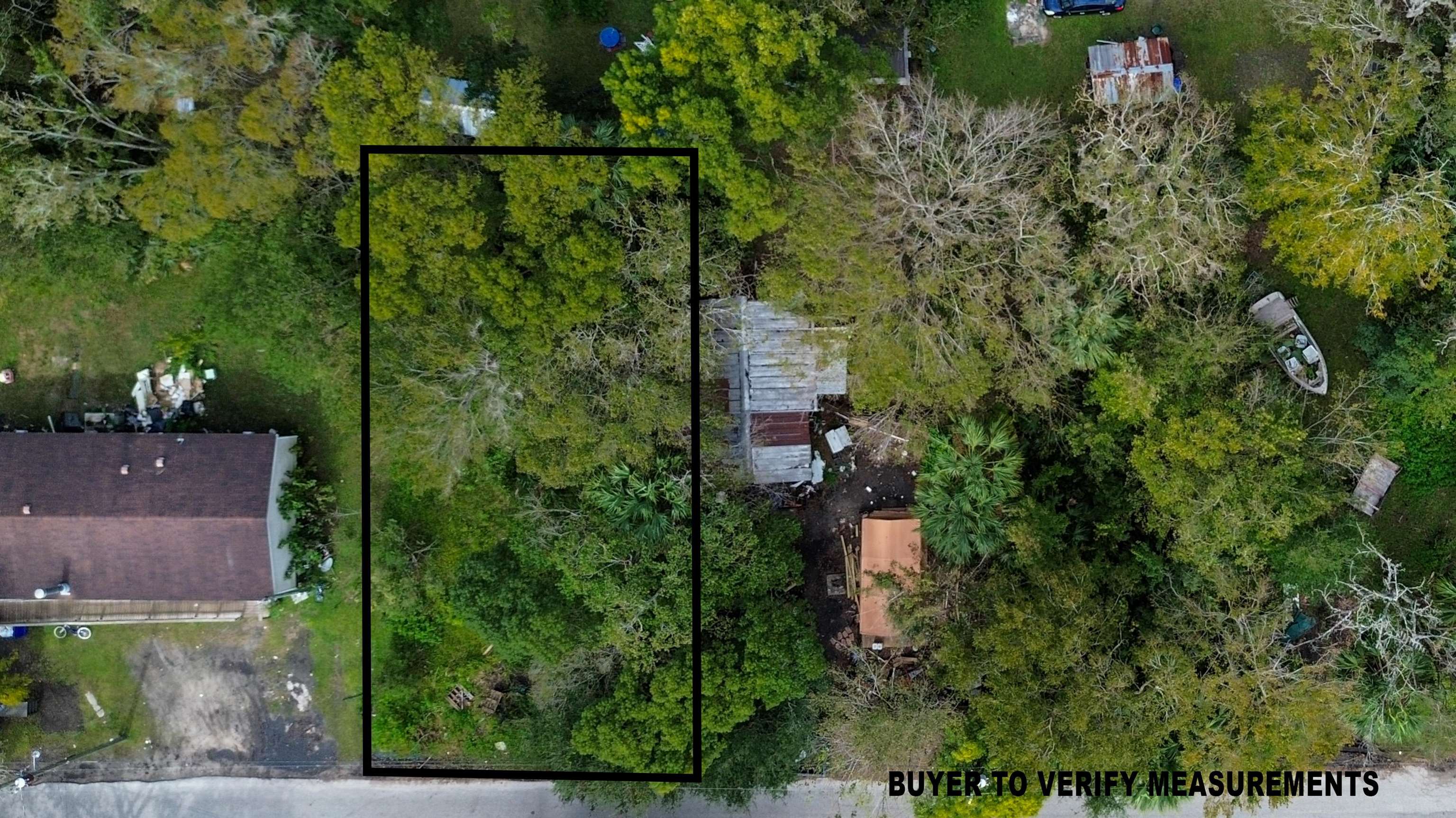 an aerial view of residential house with outdoor space and trees all around