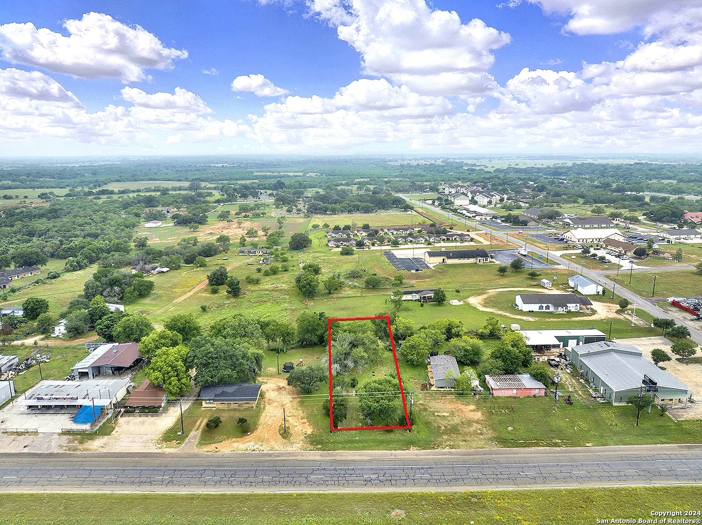 an aerial view of residential houses with outdoor space