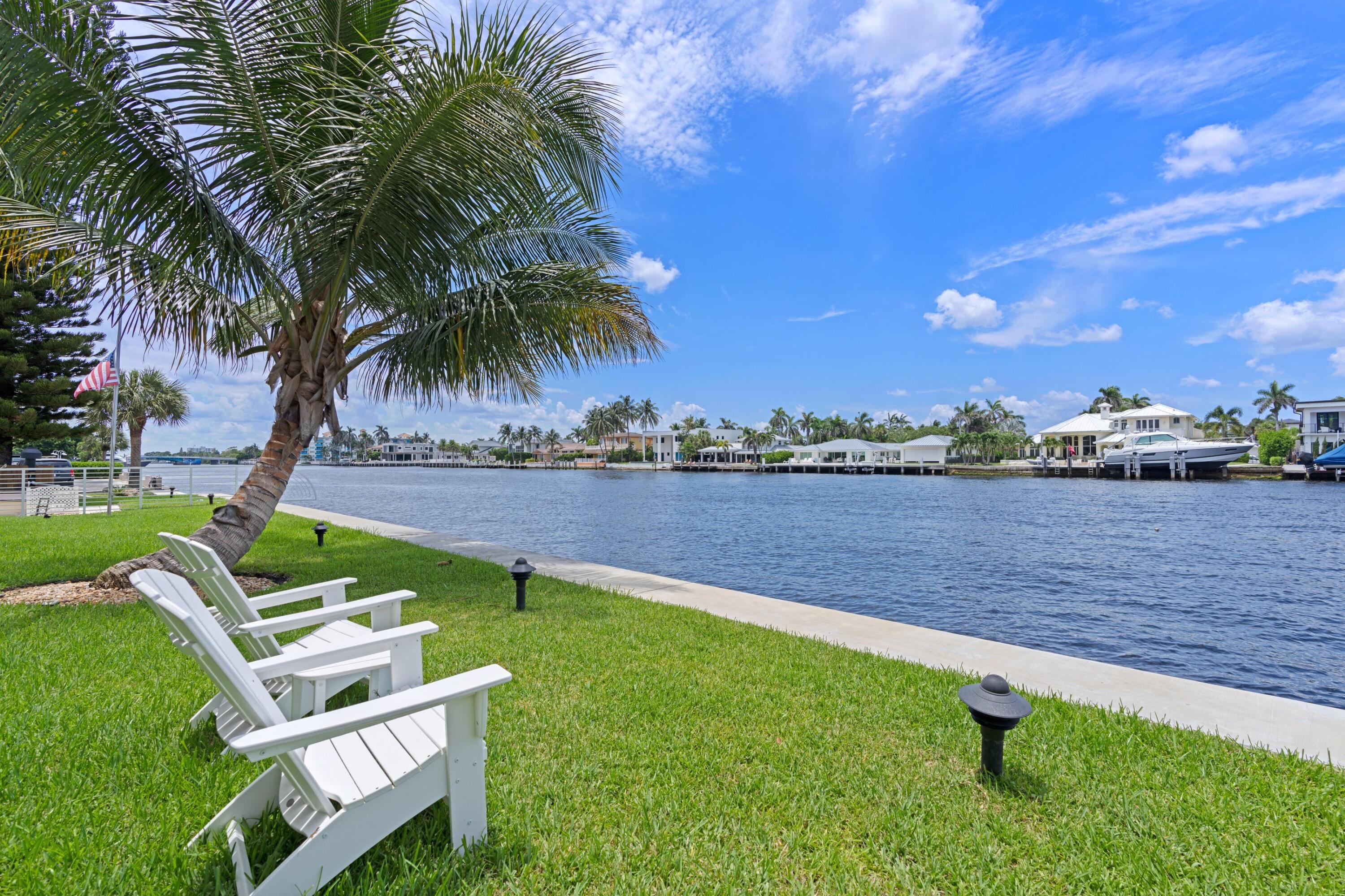 a view of a lake with couches and city view