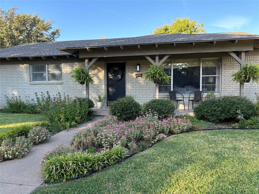 front view of a house with potted plants