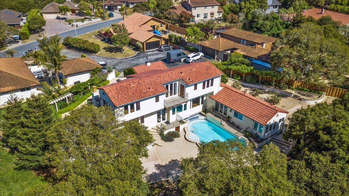 an aerial view of residential houses with outdoor space and street view