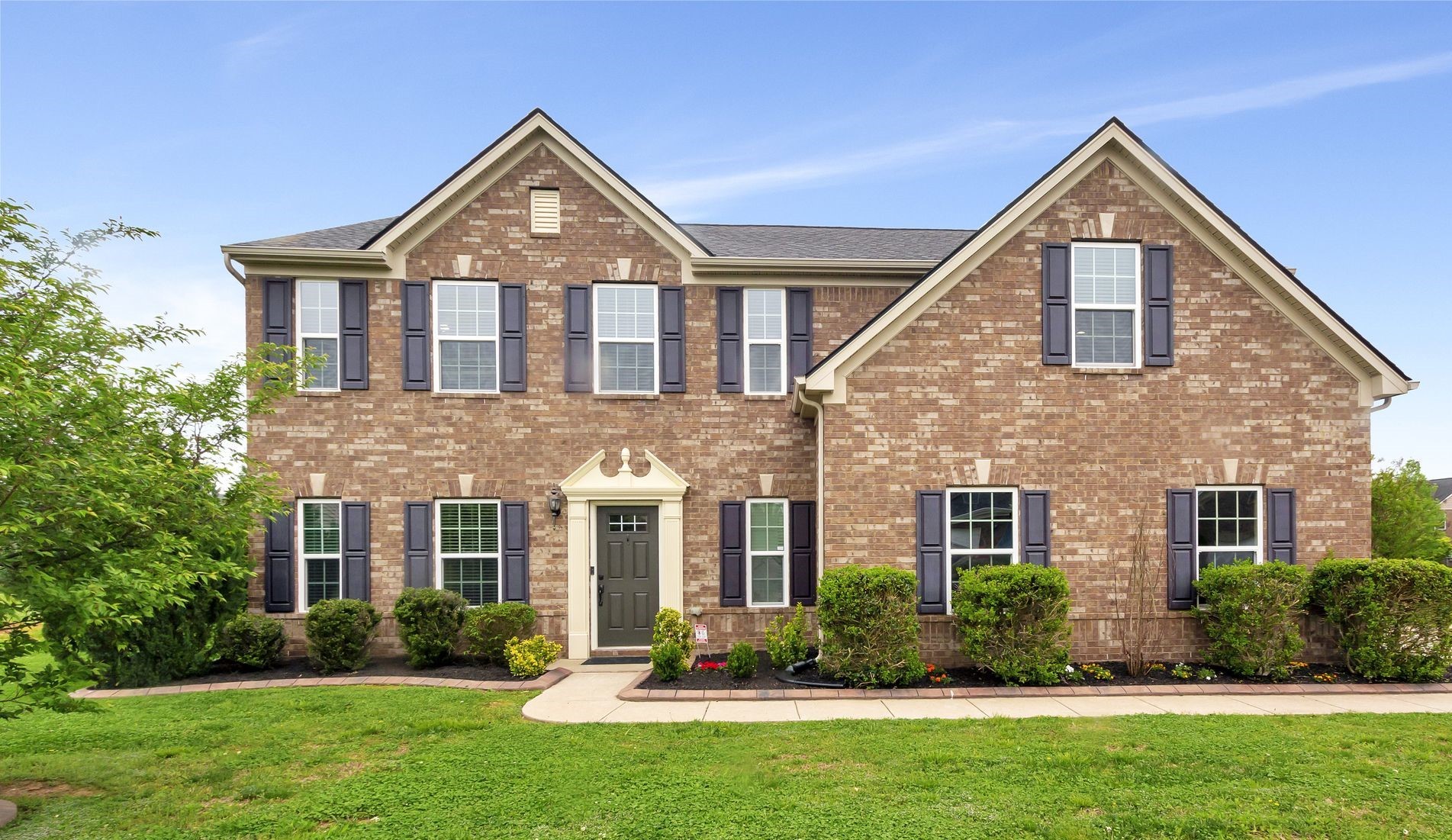 front view of a house with a yard