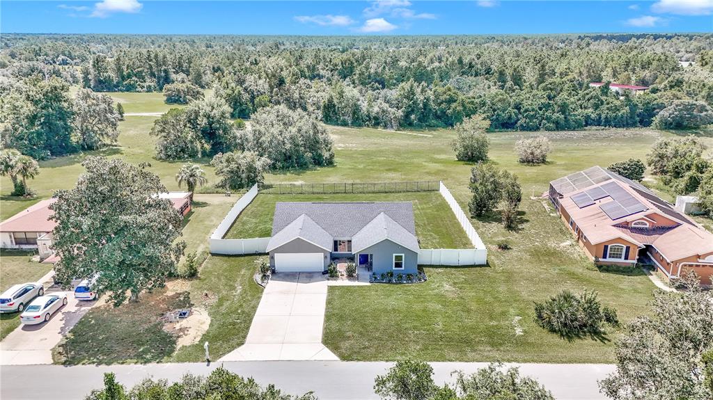 an aerial view of a house with pool lake view and mountain view