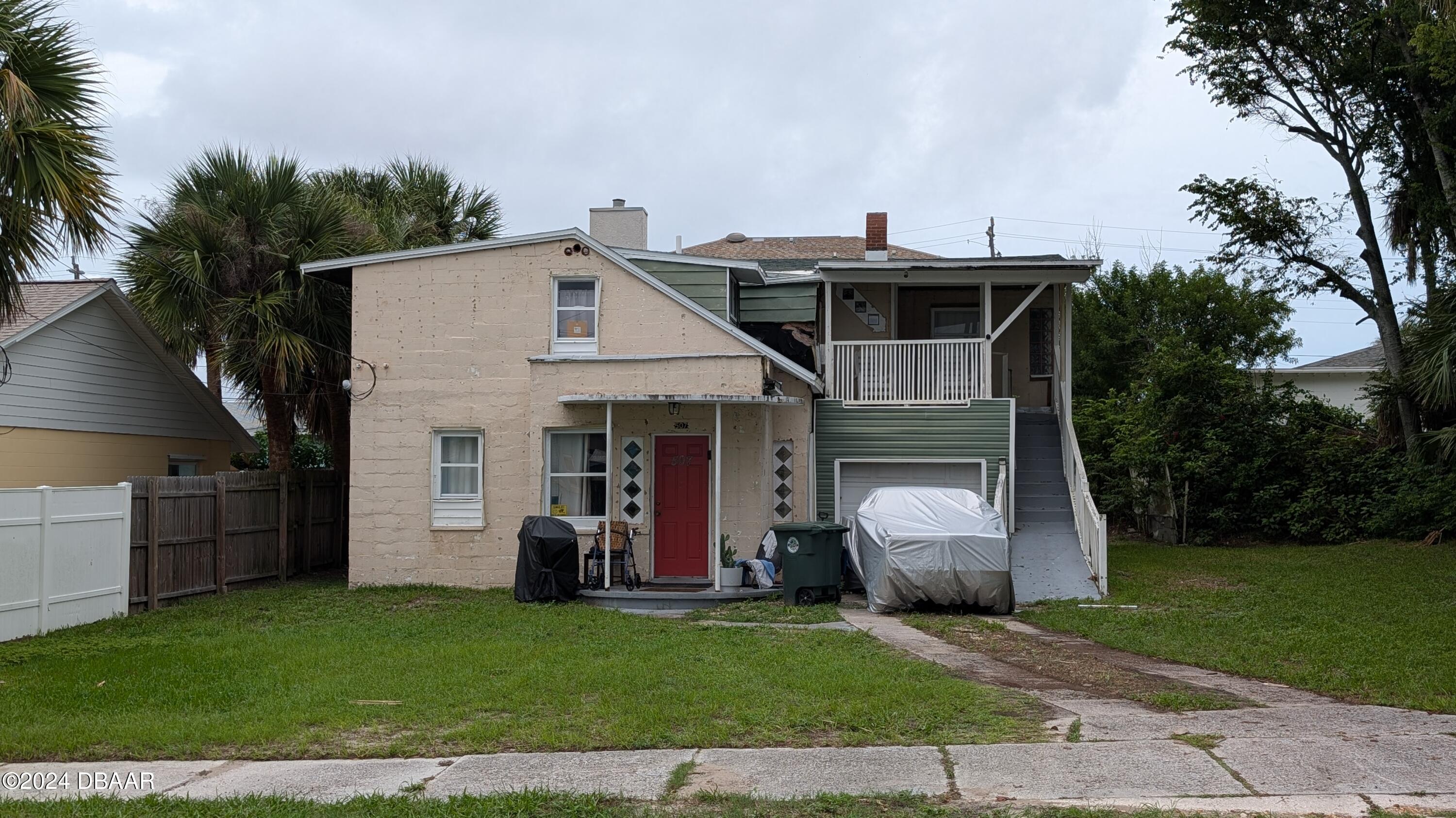 a front view of a house with a garden