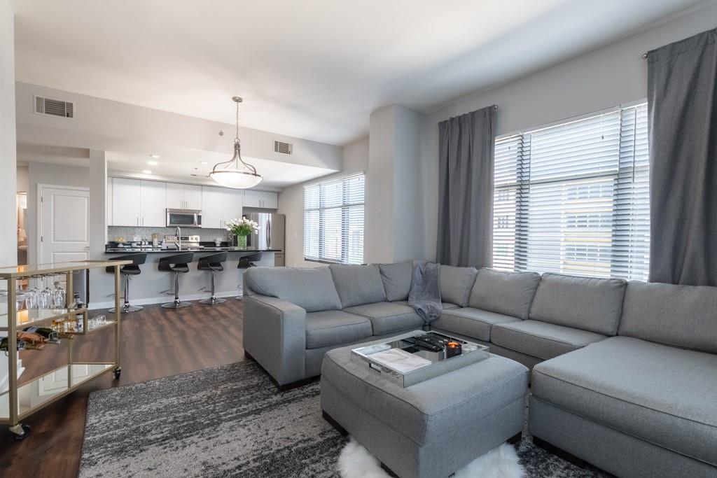 a living room with furniture and kitchen view