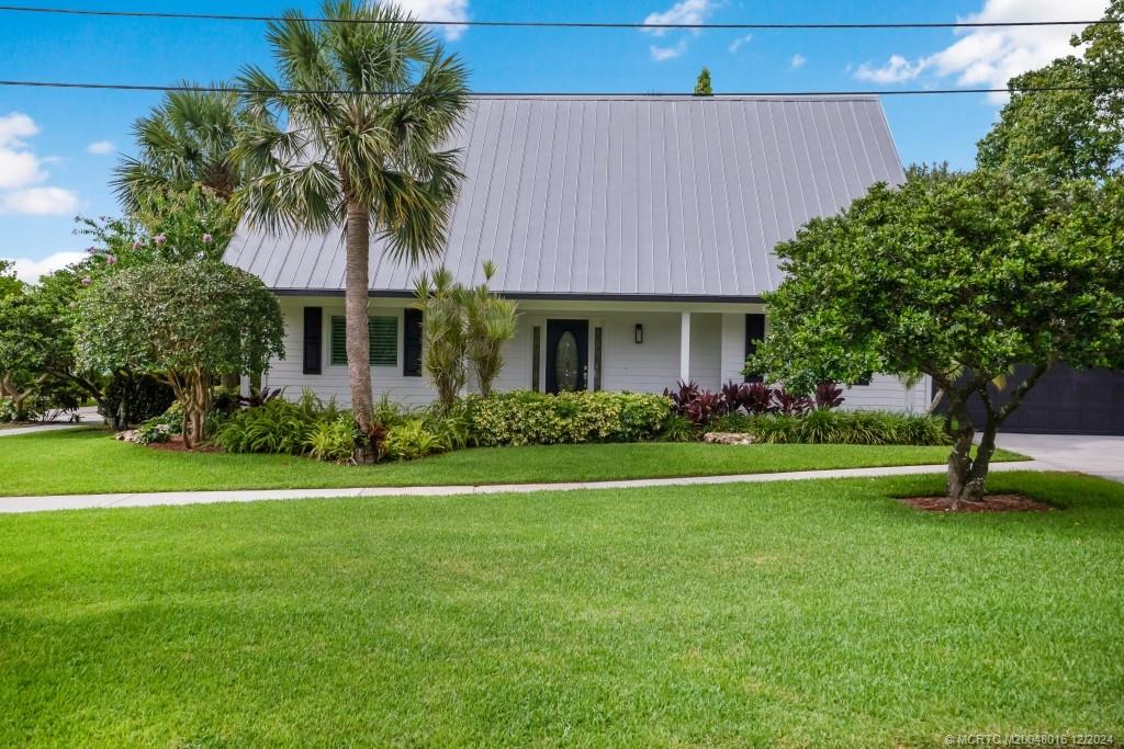 a front view of a house with a garden