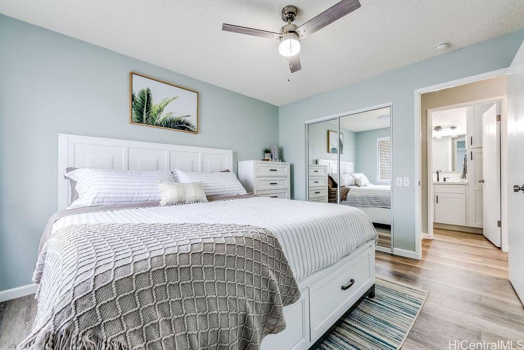 a spacious bedroom with a bed and a chandelier