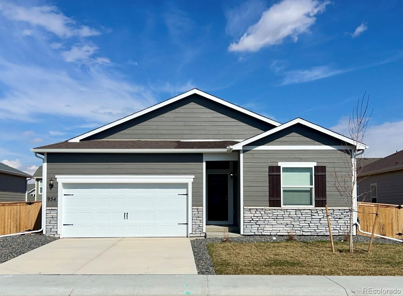 a front view of a house with garage