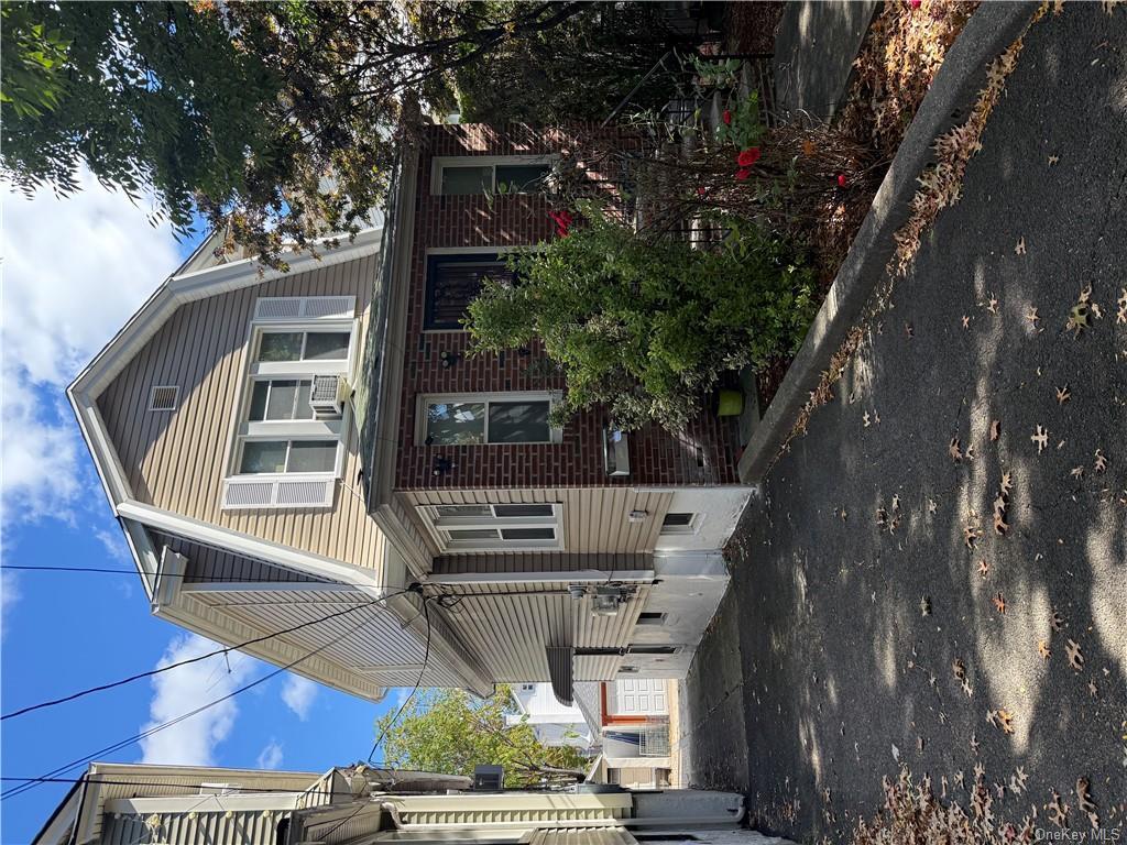 View of front of house with cooling unit and a garage