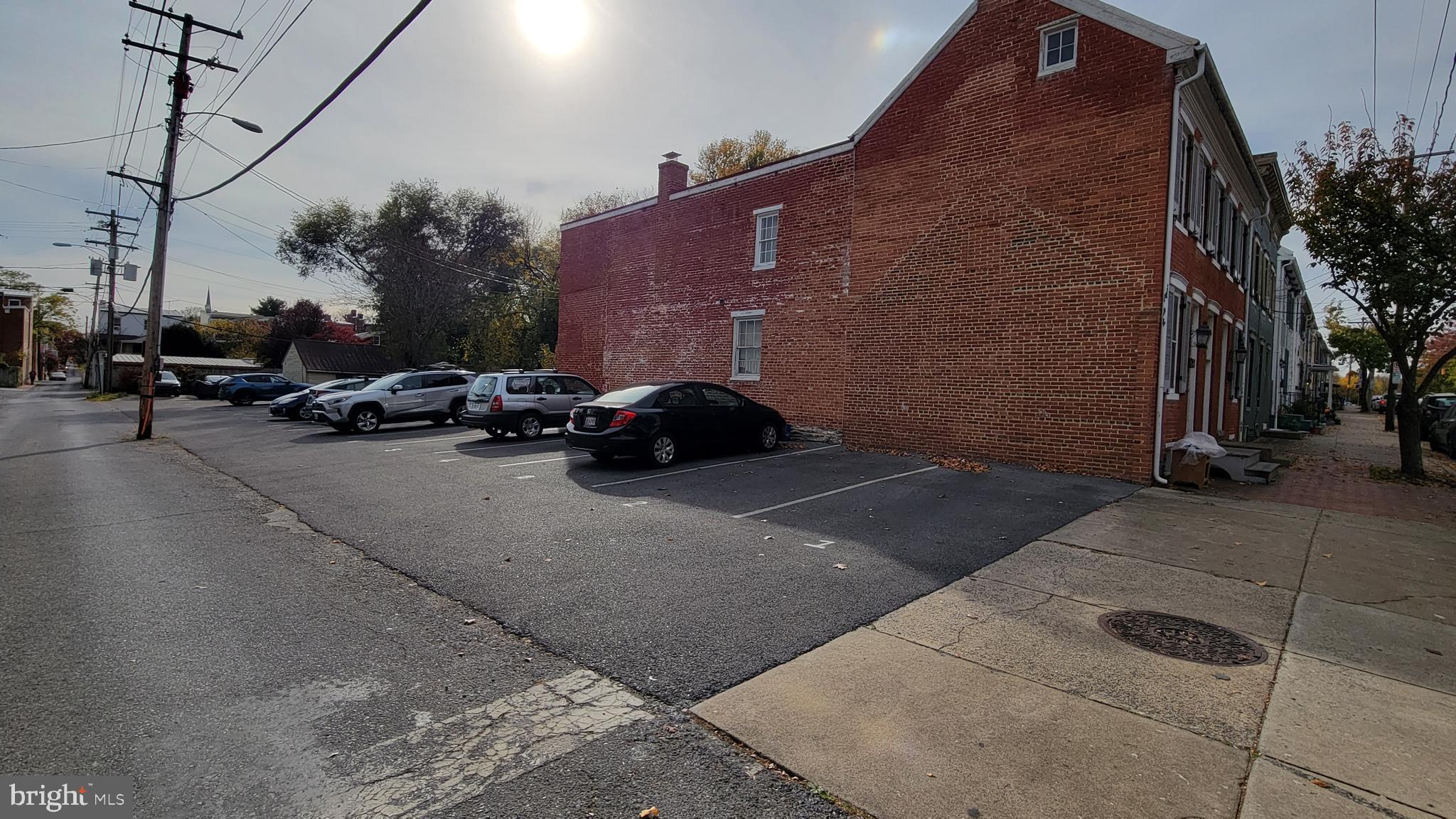 a cars parked in front of a brick building