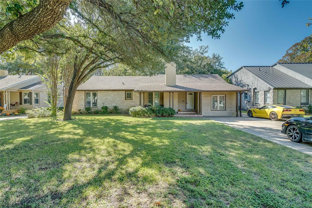 Single story home featuring a porch and a front yard