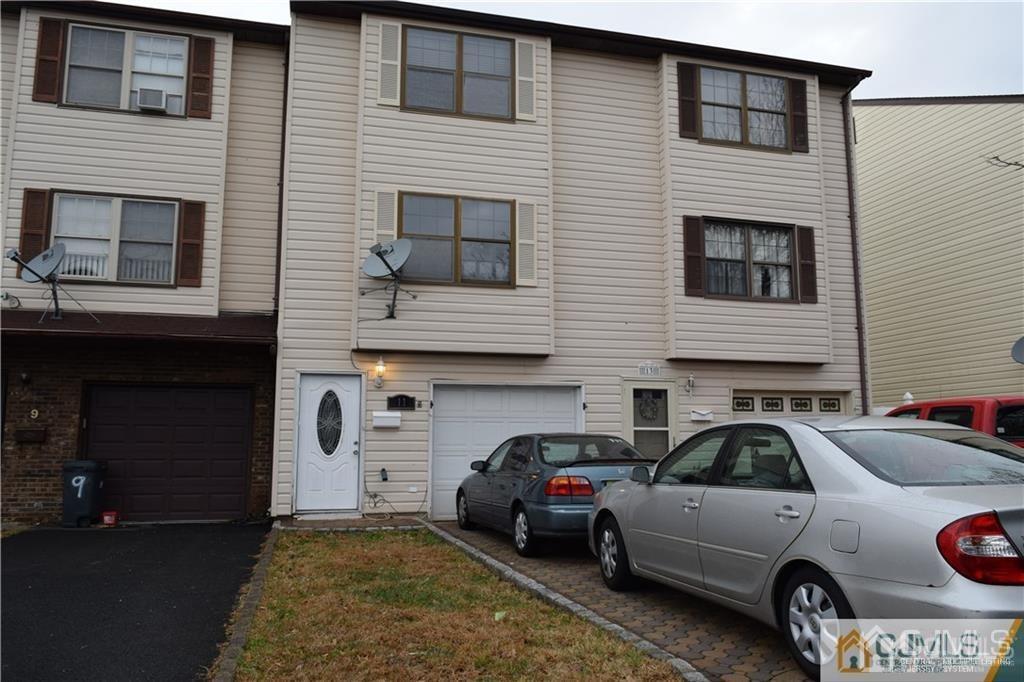 a front view of a house with parking space