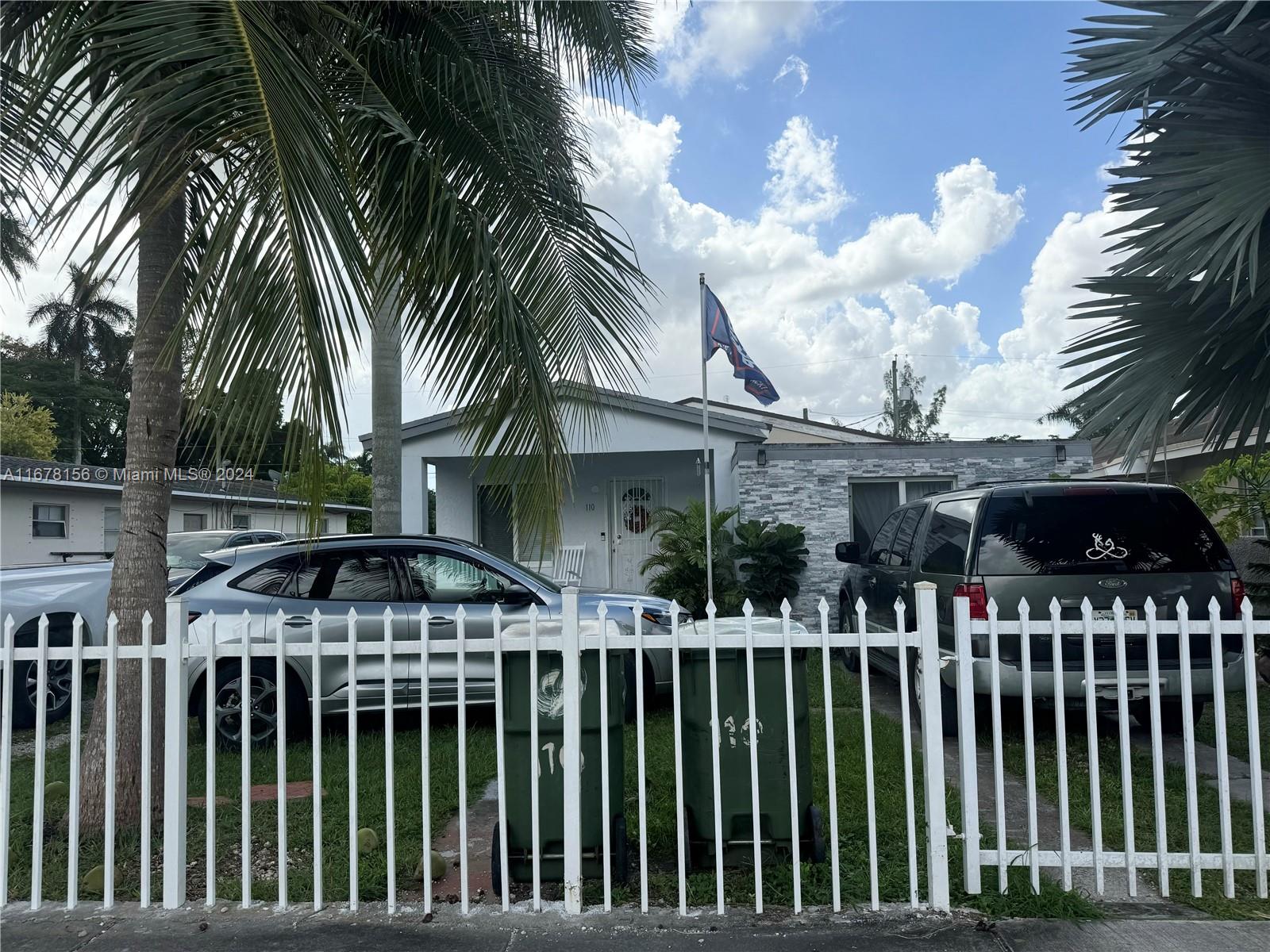 a front view of house and yard with green space