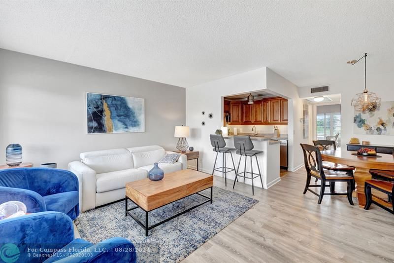 a living room with furniture a wooden floor and a flat screen tv