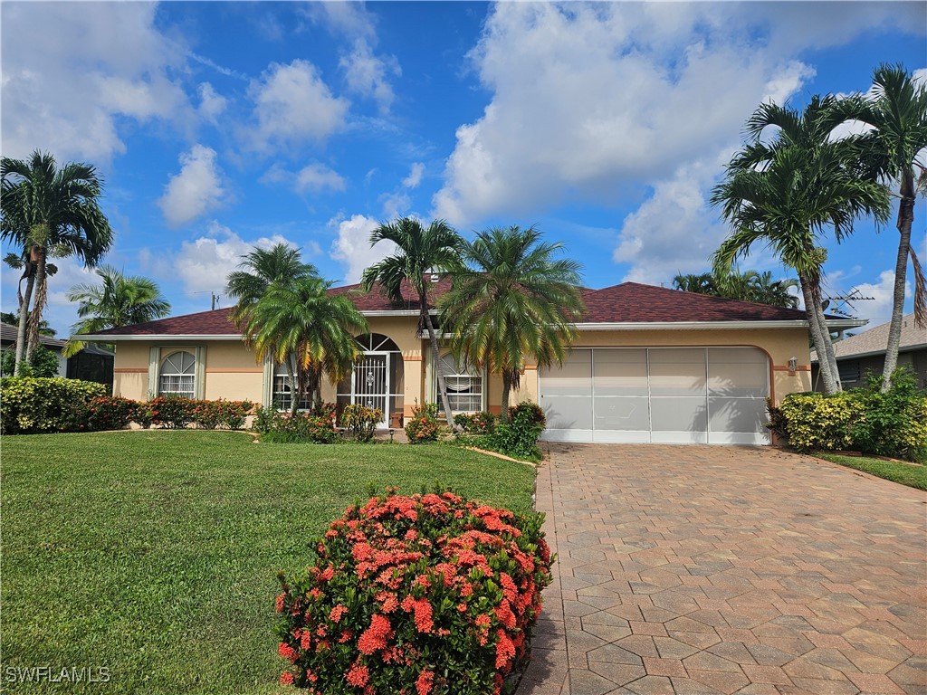 a front view of a house with a garden and trees