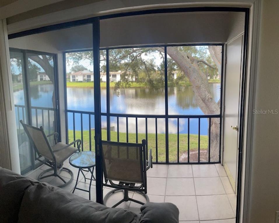 a view of a porch with chairs and backyard