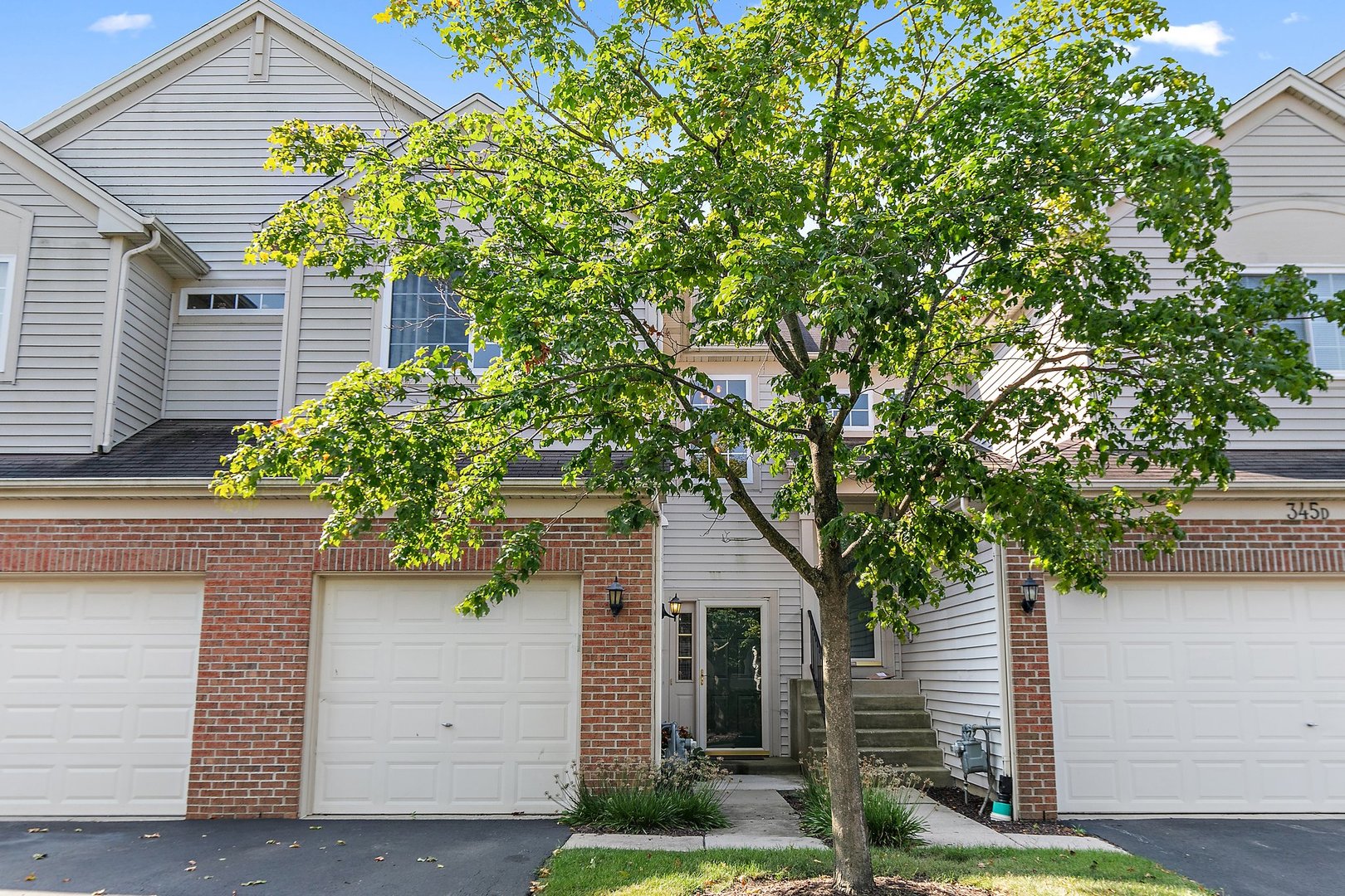 a house that has a tree in front of the house