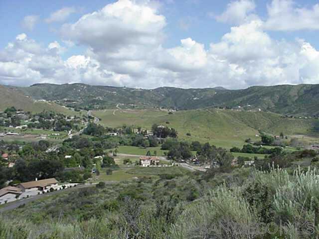 a view of a town with mountains in the background