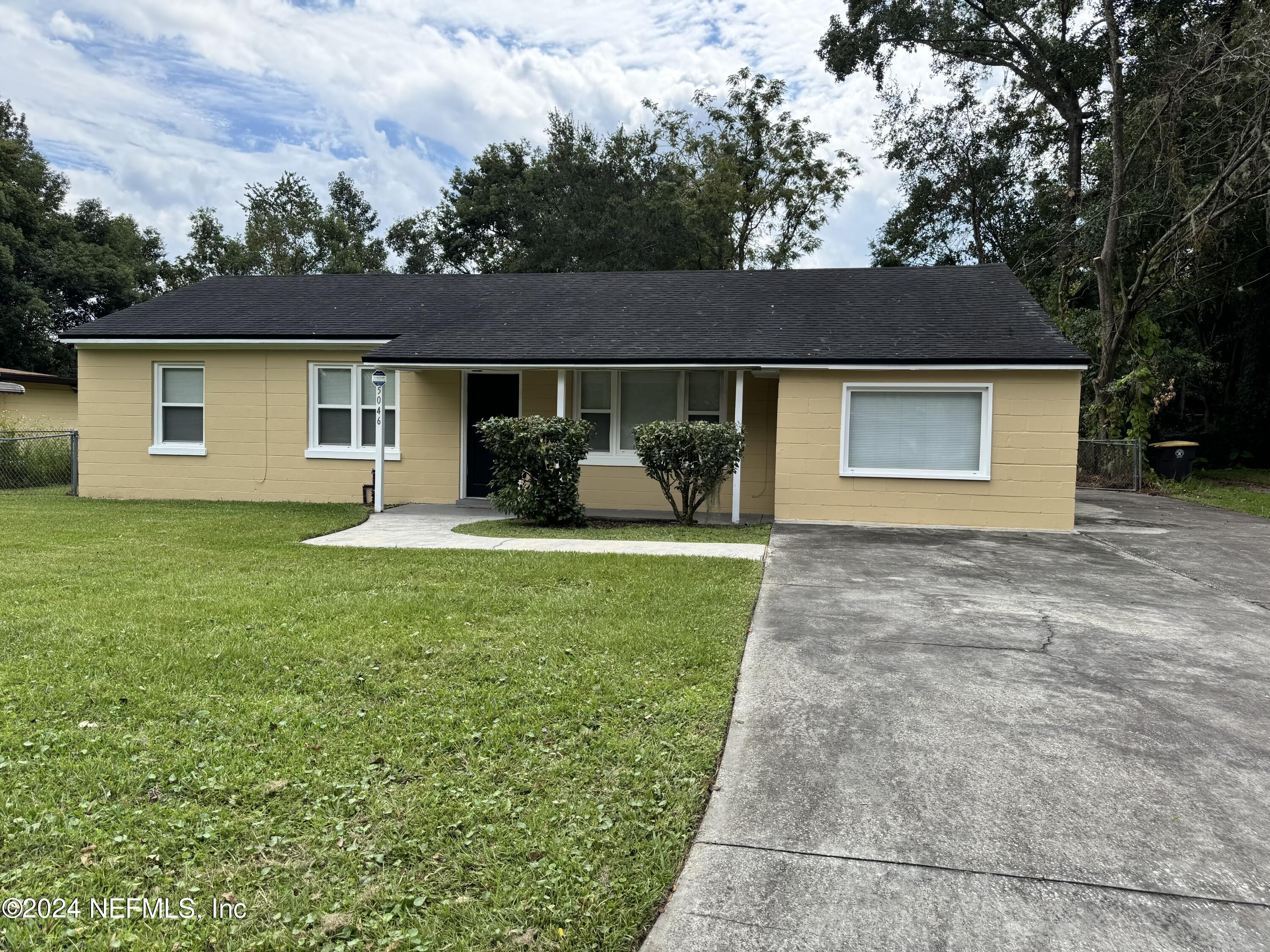 a front view of house with yard and green space