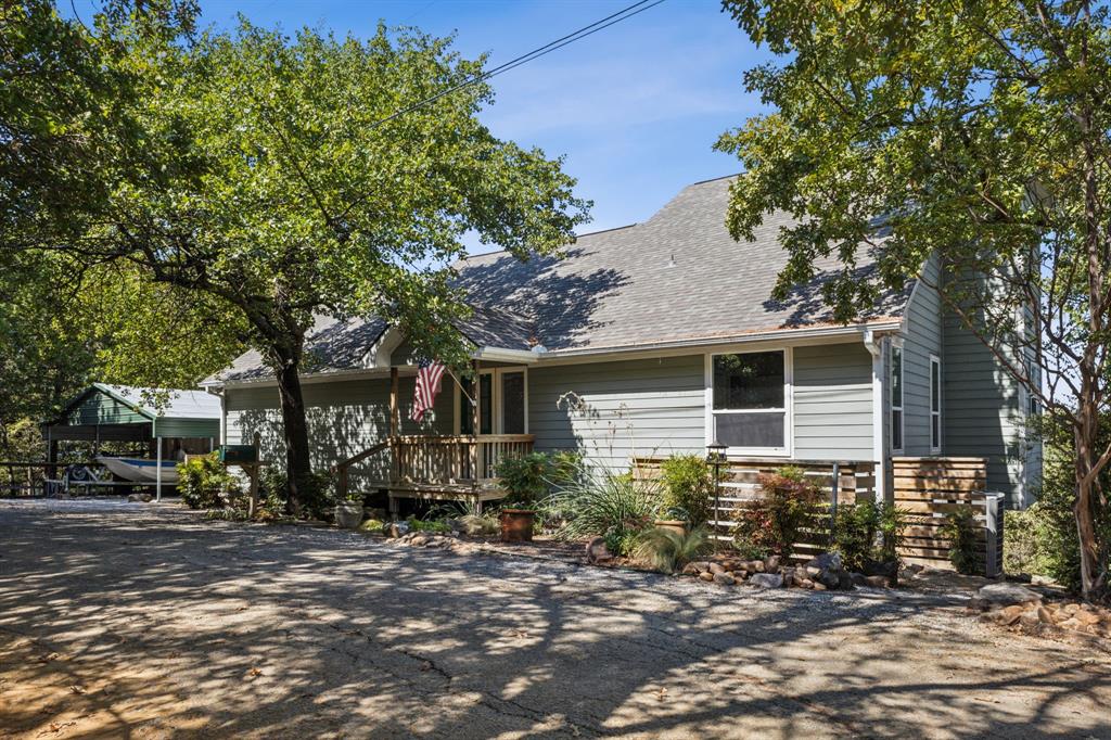 a front view of house with yard and trees around