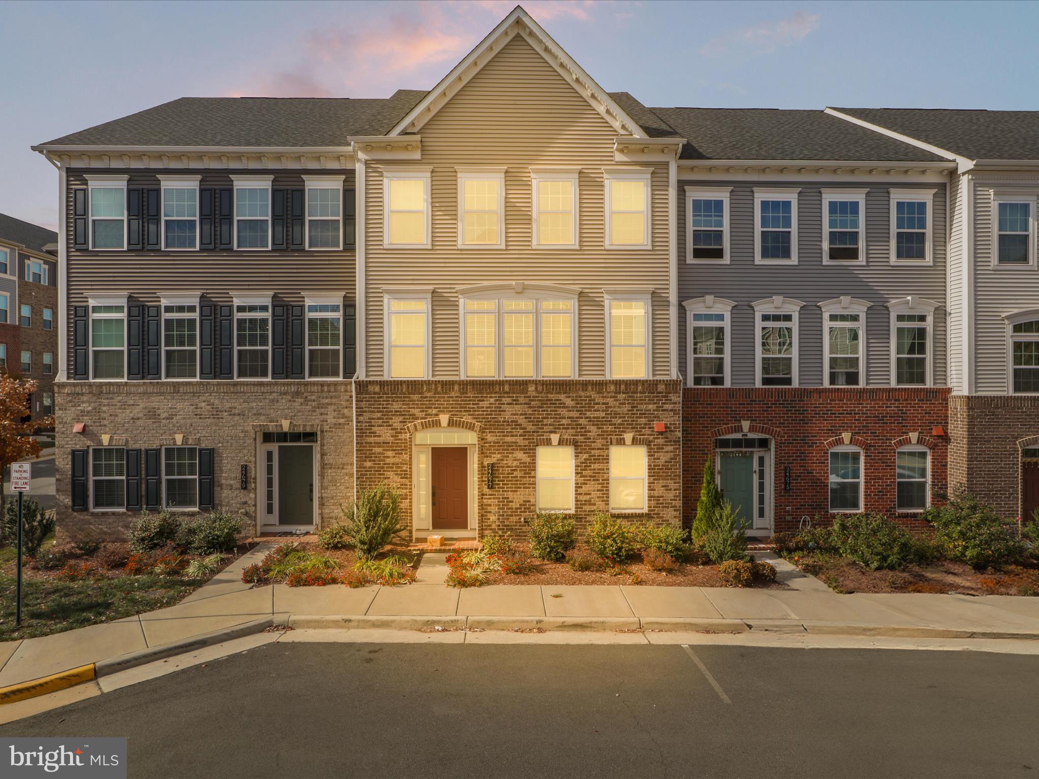 a front view of a residential apartment building with a yard