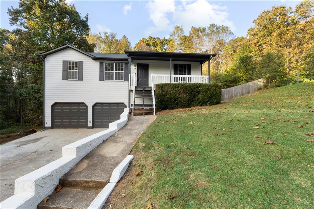 a view of a house with backyard and porch