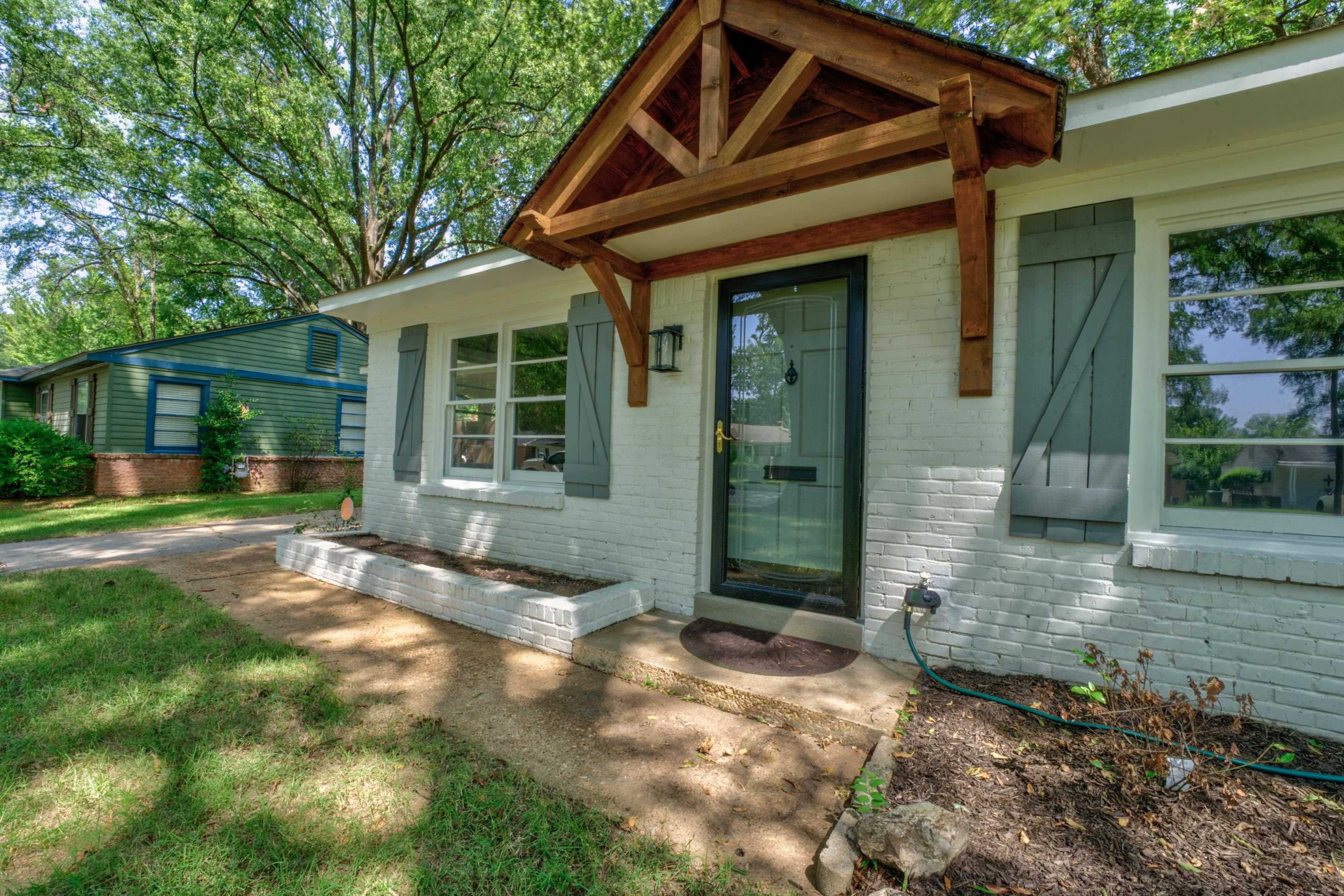 a view of house with backyard