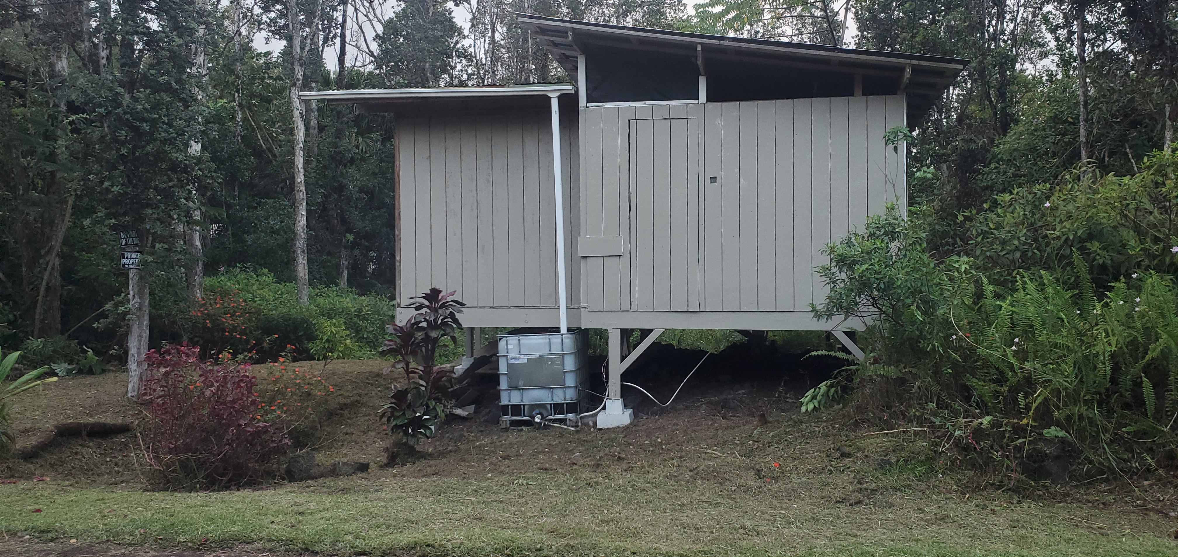 a backyard of a house with barbeque oven and outdoor seating