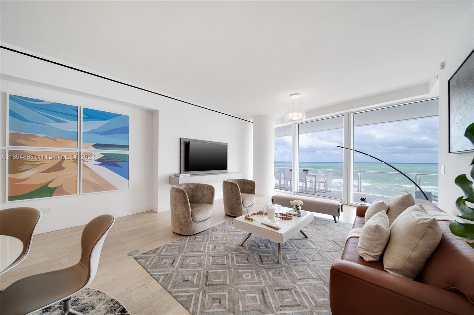 a living room with furniture a flat screen tv and a floor to ceiling window