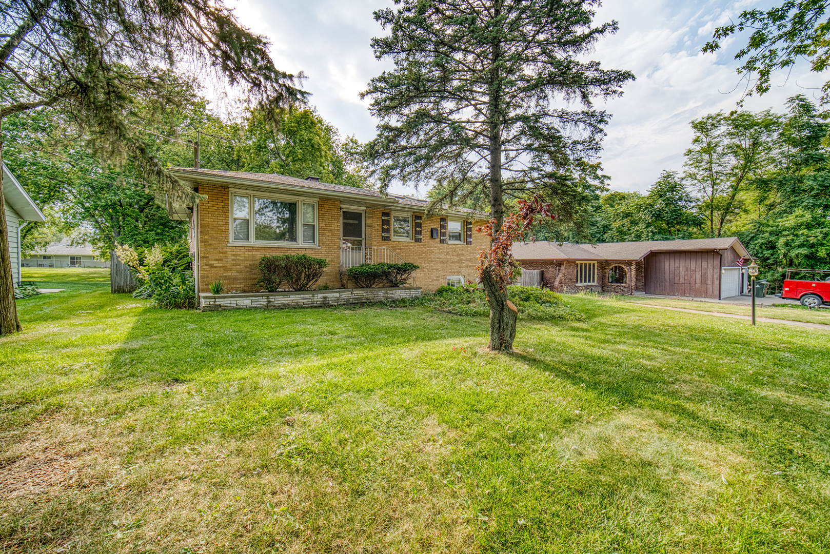 a front view of house with yard and green space