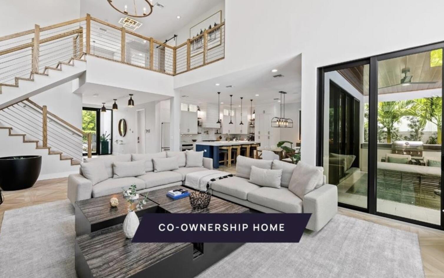 a living room with furniture a large window and a chandelier