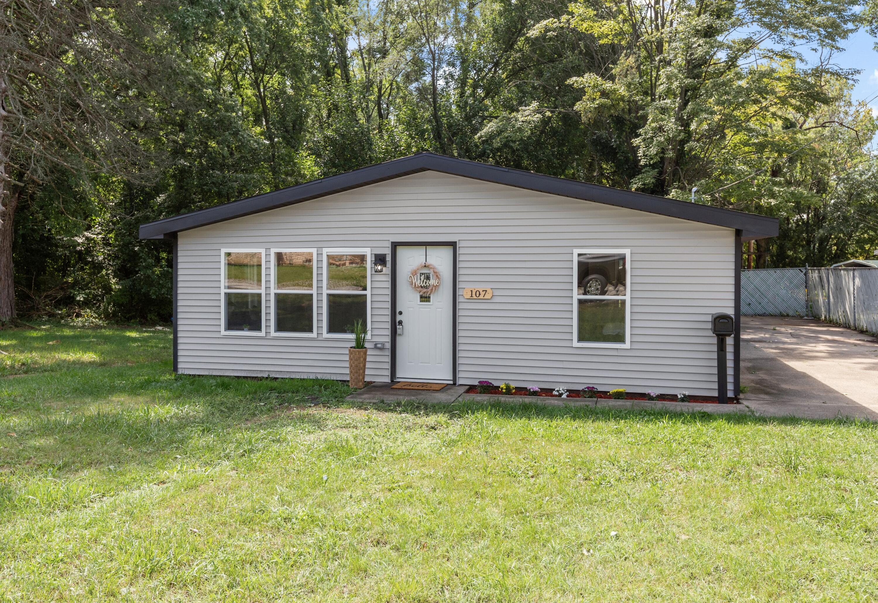 a view of a house with a yard